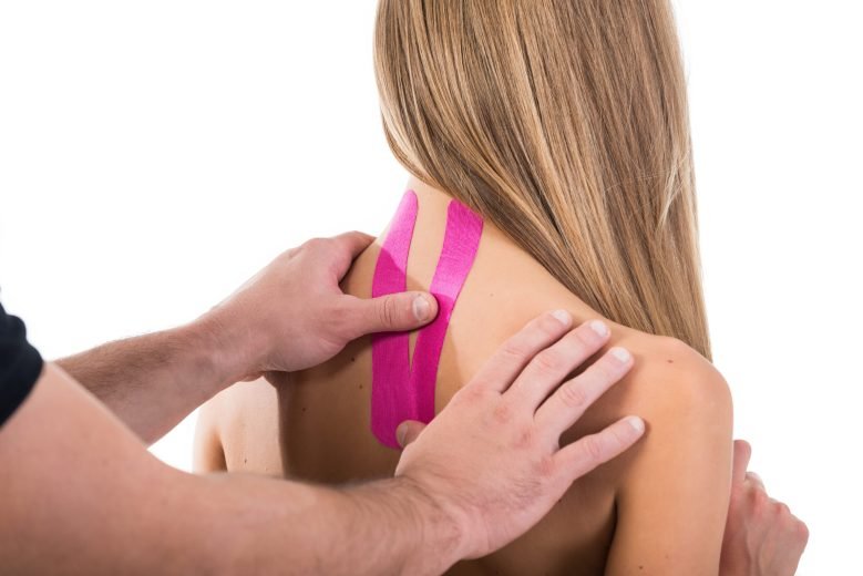 A man hands close-up sticks bright tapes on the back of a girl