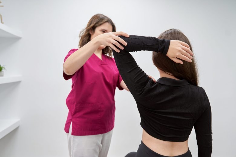 Physiotherapist examining a patient during a consultation in a medical center. Medicine and health care concept.